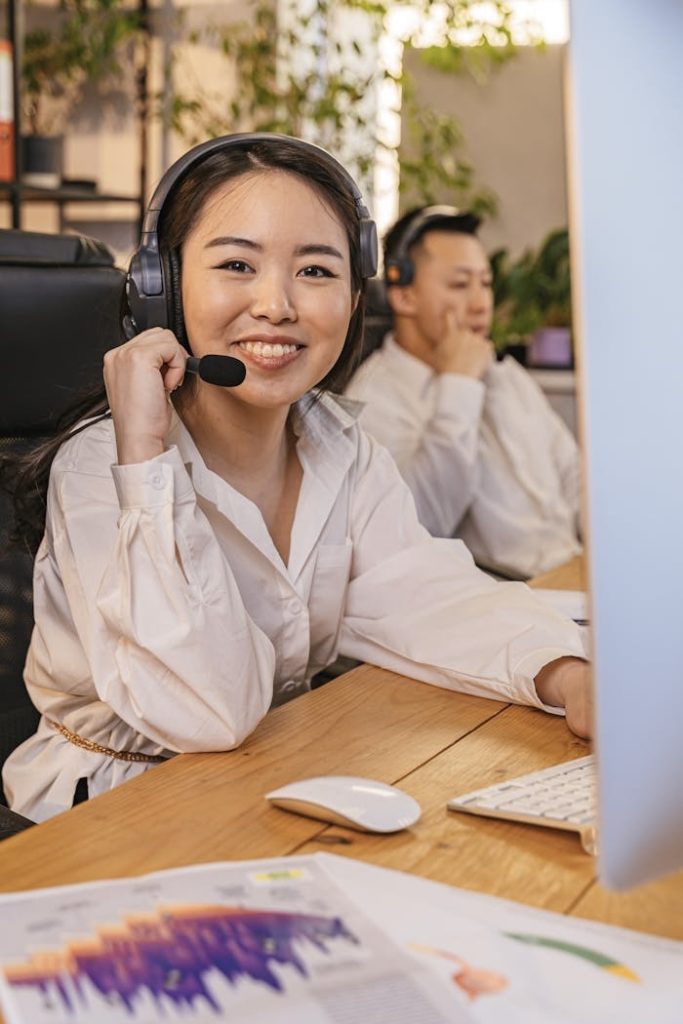 portrait-of-a-woman-wearing-a-headset-with-a-microphone-in-an-office-8191959